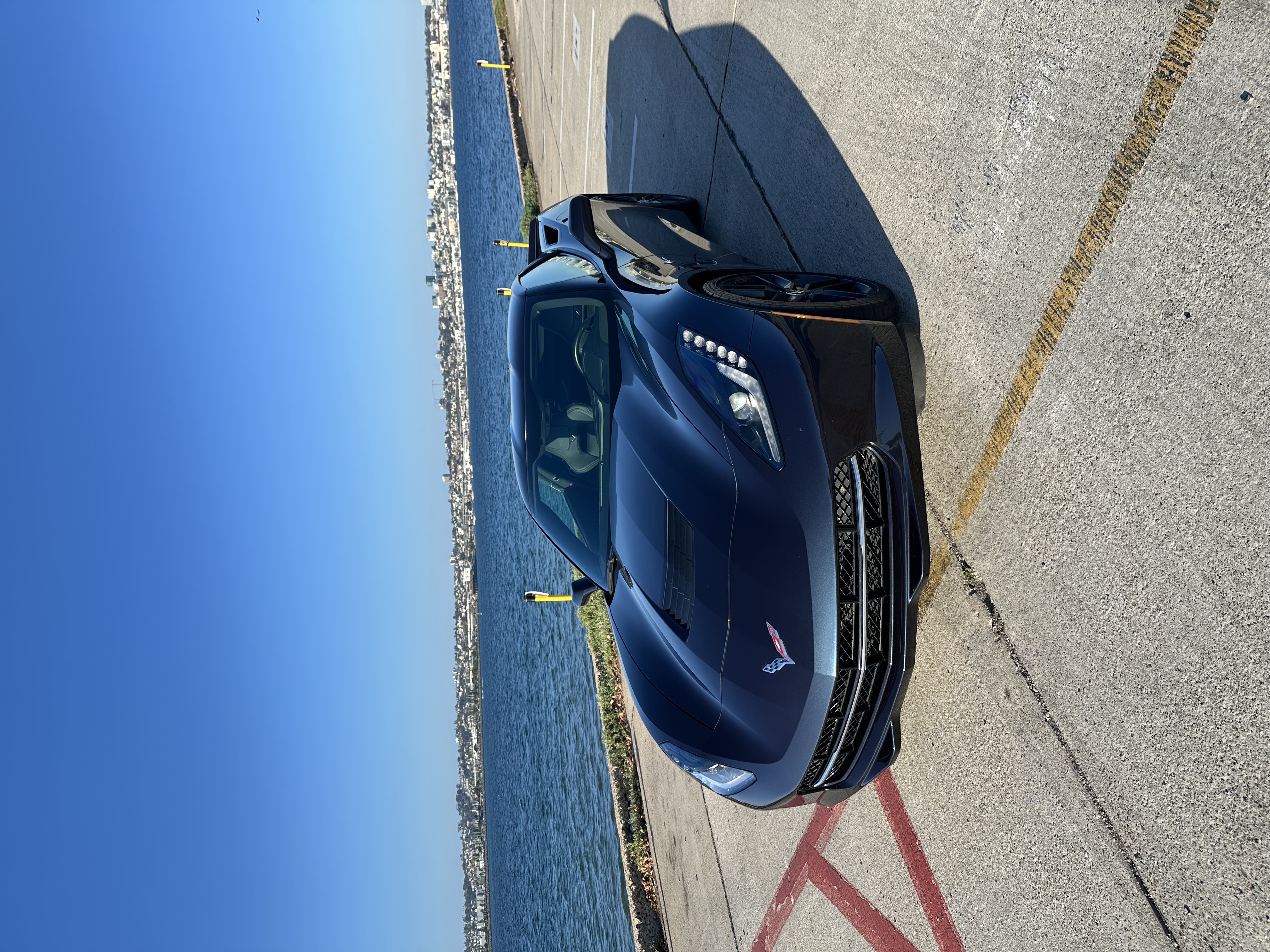 Premium vehicles at Roltek Investments with San Diego Bay waterfront